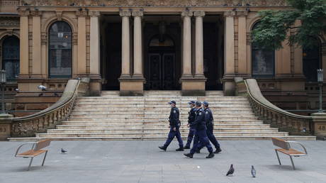 Police officers patrol the city center during a law enforcement operation amid the Covid-19 lockdown in Sydney, Australia.