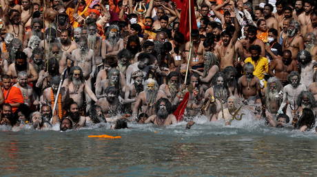 Naga Sadhus, or Hindu holy men take a holy dip in the Ganges River during Shahi Snan at "Kumbh Mela", or the Pitcher Festival, amidst the spread of the coronavirus disease (COVID-19), in Haridwar, India, April 14, 2021. © REUTERS/Anushree Fadnavis