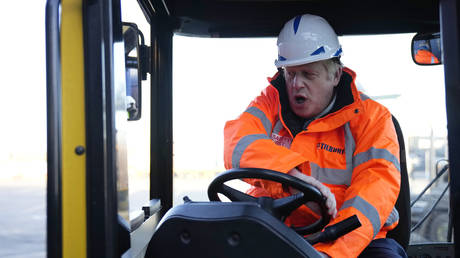 British Prime Minister Boris Johnson drives a forklift during a visit to Tilbury Docks on January 31, 2022 © Photo by Matt Dunham - WPA Pool/Getty Images